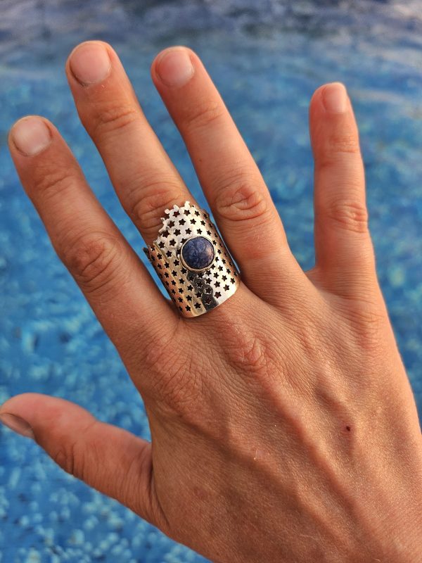 Wide silver ring of the author's design with natural sodalite.